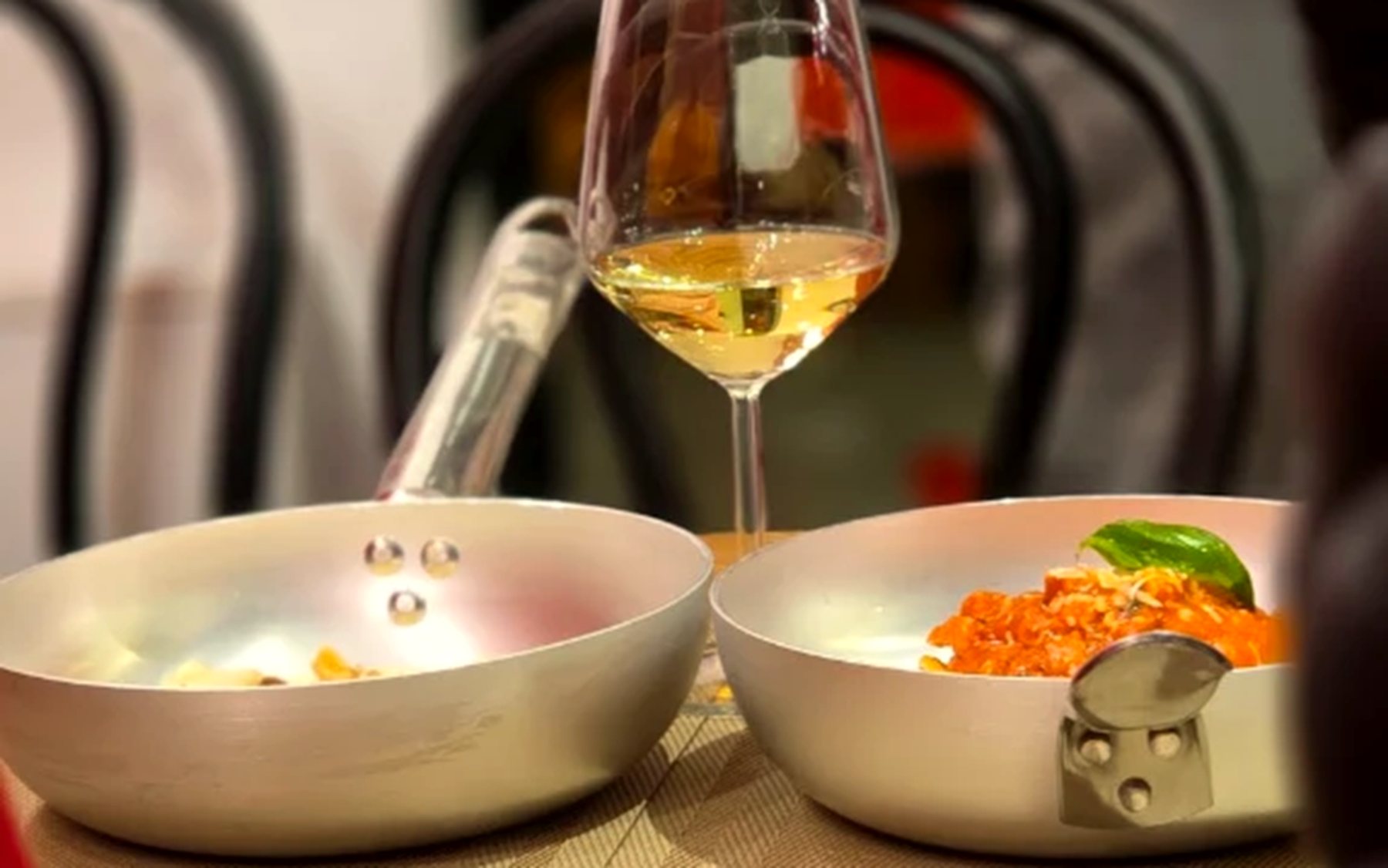 Pasta served in pans with a glass of white wine at ArtePasta
