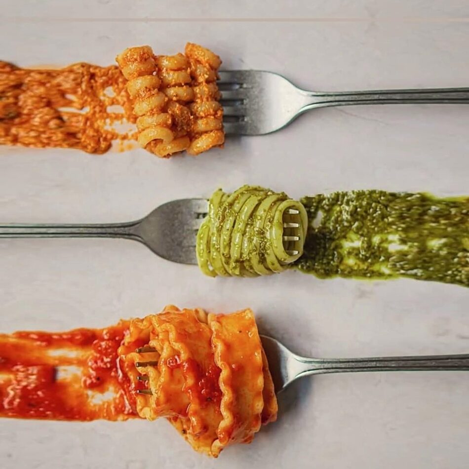 Three forks of pasta with different sauces